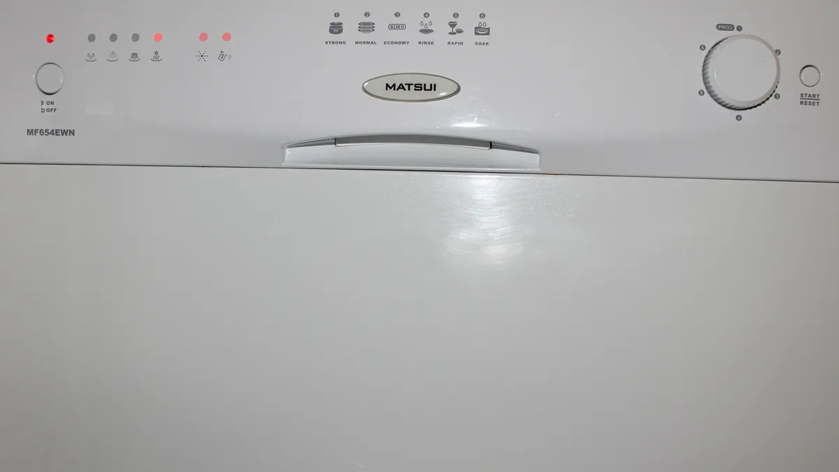 White dishwasher door with a row of push buttons and a cycle knob
