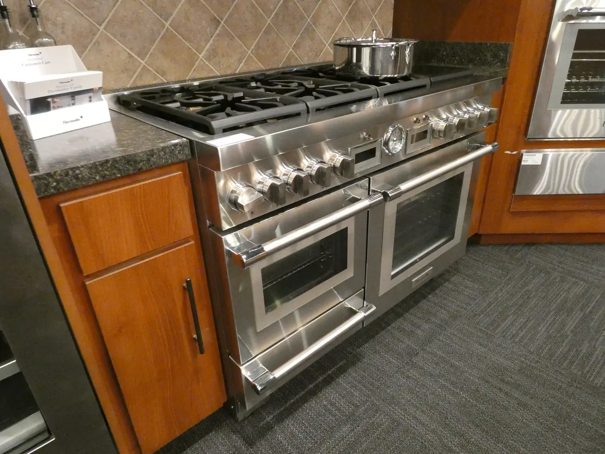 Pro-style stainless range with two oven doors and six burners on display